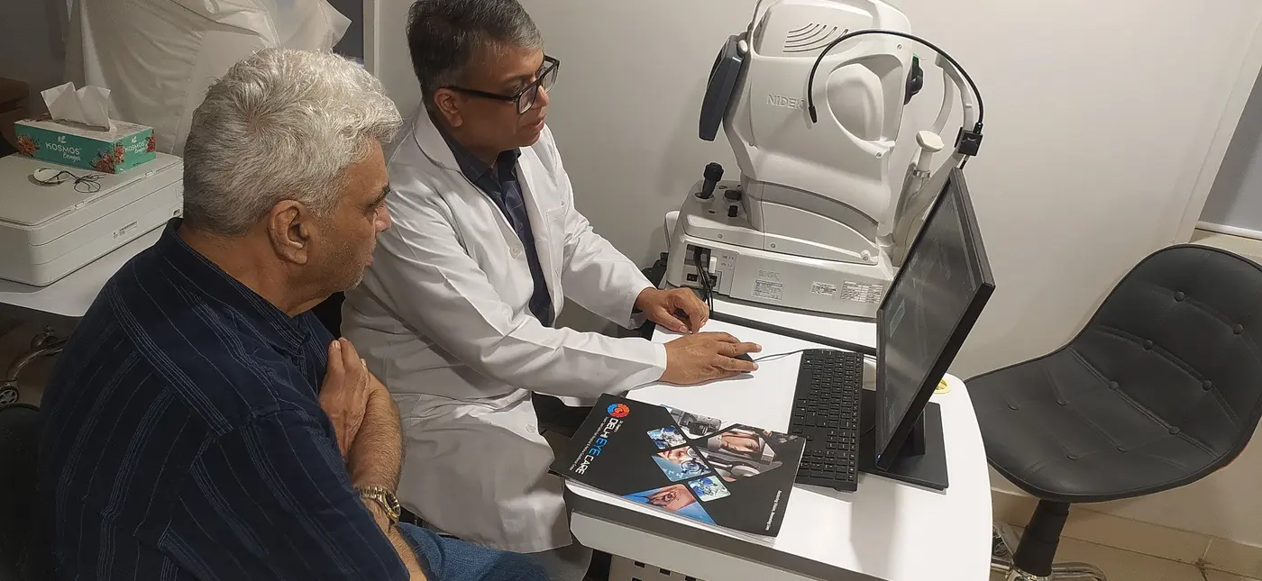 Dr. Shashank Rai Gupta discussing retinal scans and treatment decisions with a patient