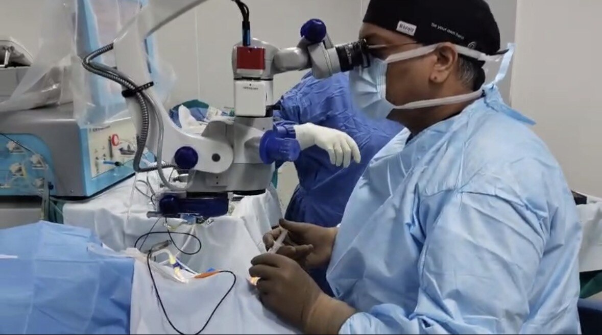 Dr. Shashank Rai Gupta performing microscope-guided retinal surgery in the operating theatre