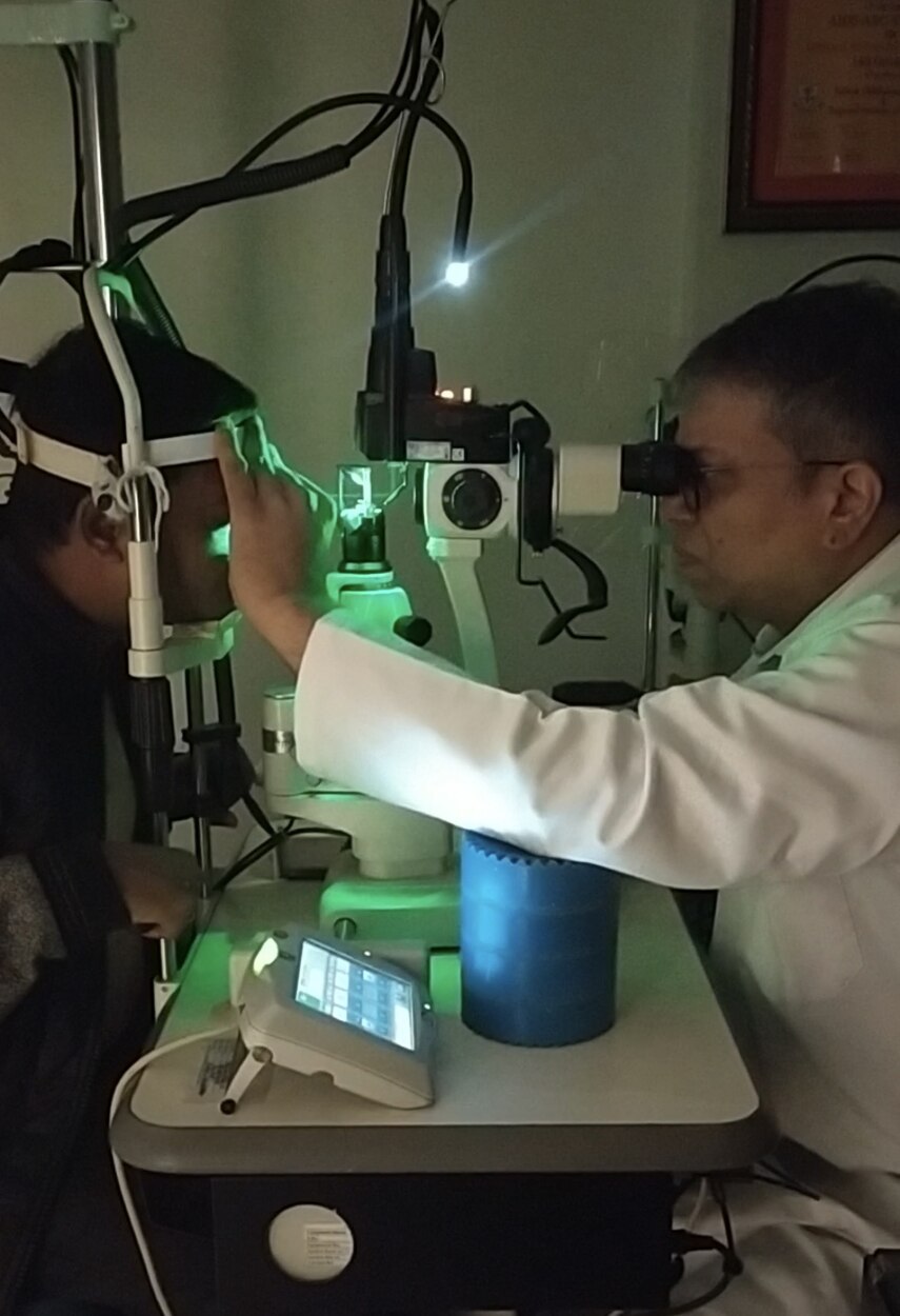 Dr. Shashank Rai Gupta performing green retinal laser treatment at the slit lamp